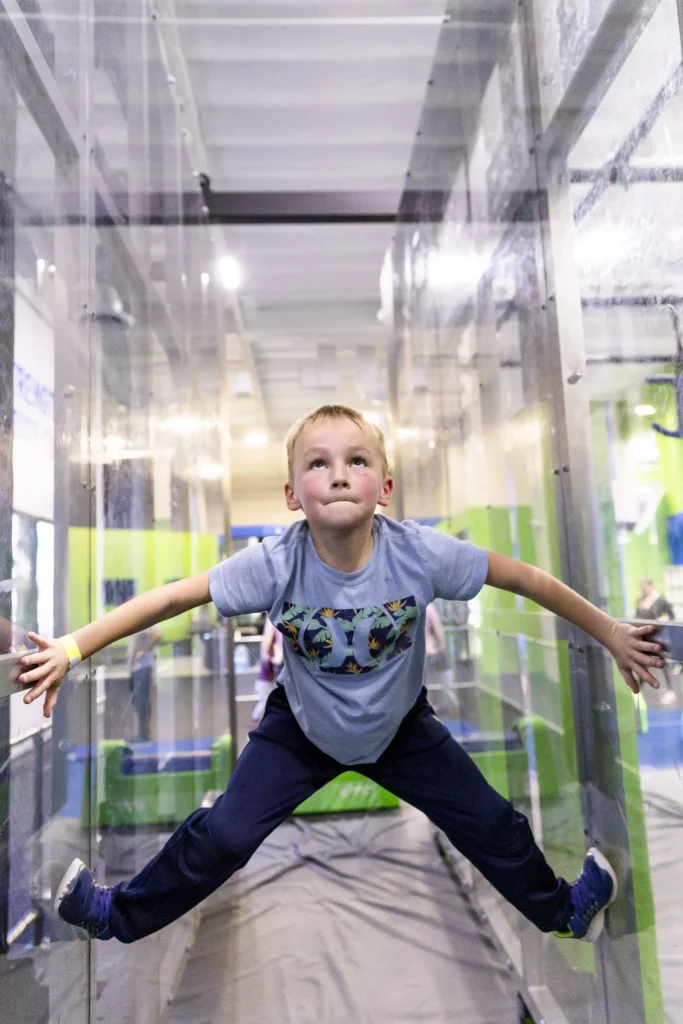 Young Ninja Tackles Obstacles with Help of Instructor